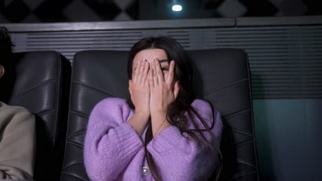 asian woman sitting in a vip cinema.