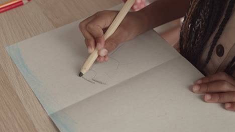 unrecognizable kid drawing person