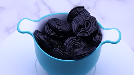 black licorice candies on white background