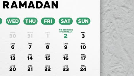 primer plano de una hermosa página del calendario de pared con un horario de los días de ayuno de ramadán 2022 y la cámara se mueve a la fecha de eid al-fitr