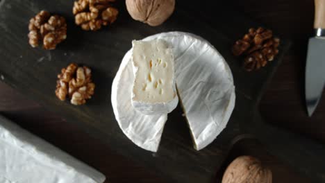 camembert cheese with walnuts rotates slowly.