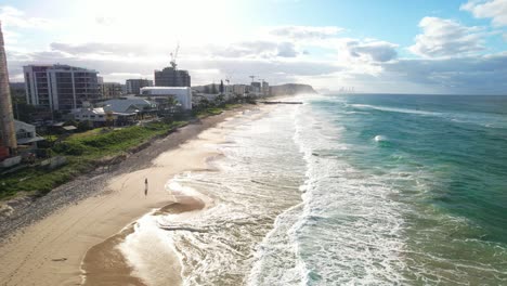 foamy ocean waves at palm beach in queensland, australia - drone shot