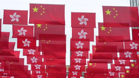 flags of the people's republic of china and the hong kong sar are seen in a street during hong kong's handover to china anniversary