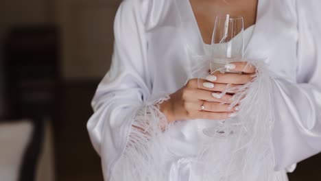 close up view on female hand holding glass of cold champagne