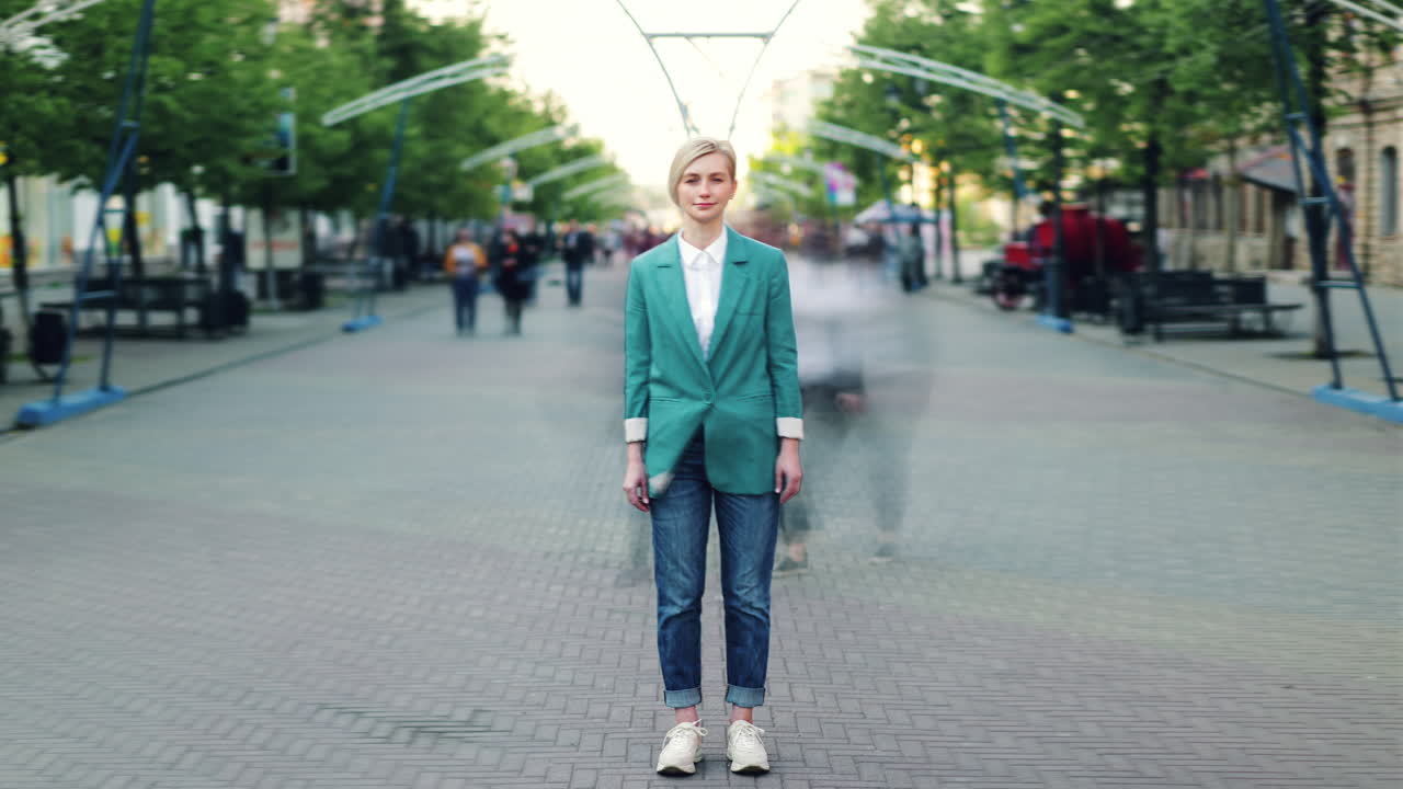 Woman in a teal blazer on city street