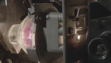 closeup of the bulb of an 8mm projector that is on, shutter at 16 fps