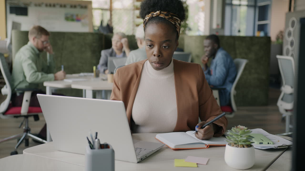 Businesswoman taking notes in a modern office