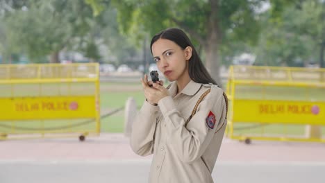 indian female police officer posing with handgun