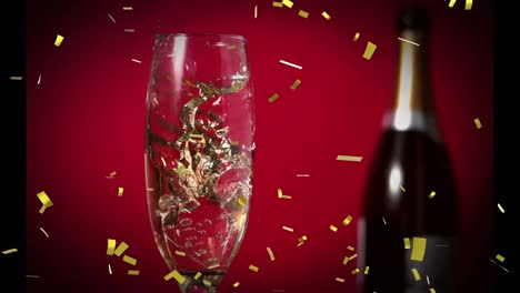 Animation-of-gold-confetti-falling-over-glass-of-champagne