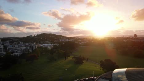 glowing sunburst over Auckland war memorial museum dome at early morning, aerial