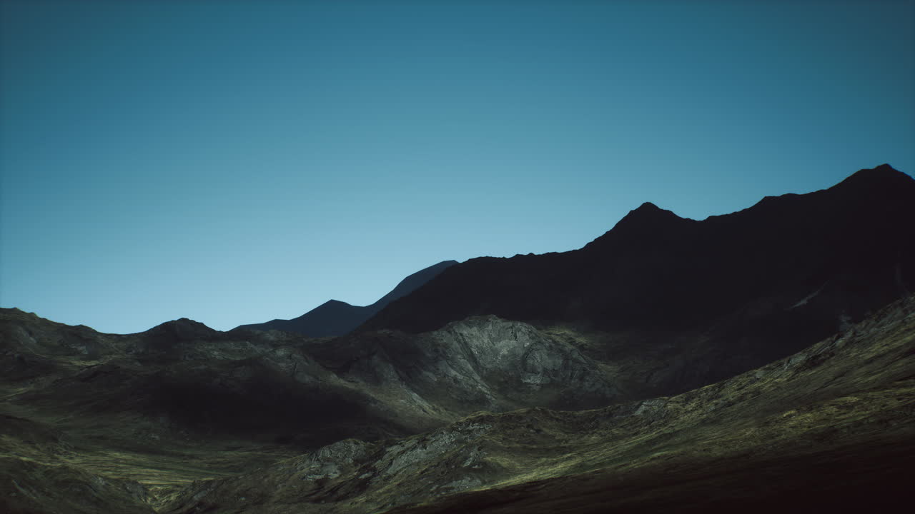 Majestic mountain landscape at dusk under a clear sky in a remote area
