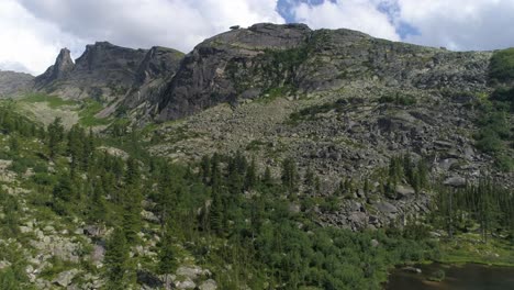 aerial view of a mountain range with rocky terrain and lush forest