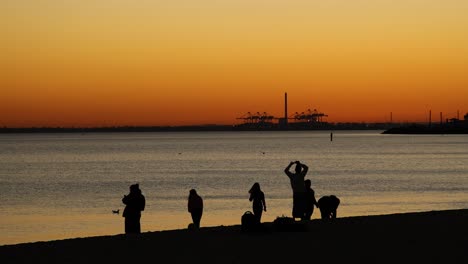 people enjoying sunset at st kilda beach