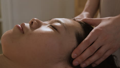 woman receiving a relaxing head and scalp massage