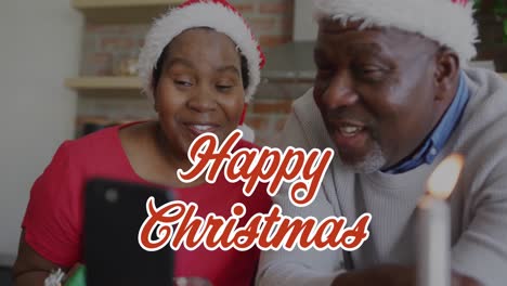 animación de felicitaciones de navidad texto sobre pareja afroamericana en teléfono inteligente llamada en navidad