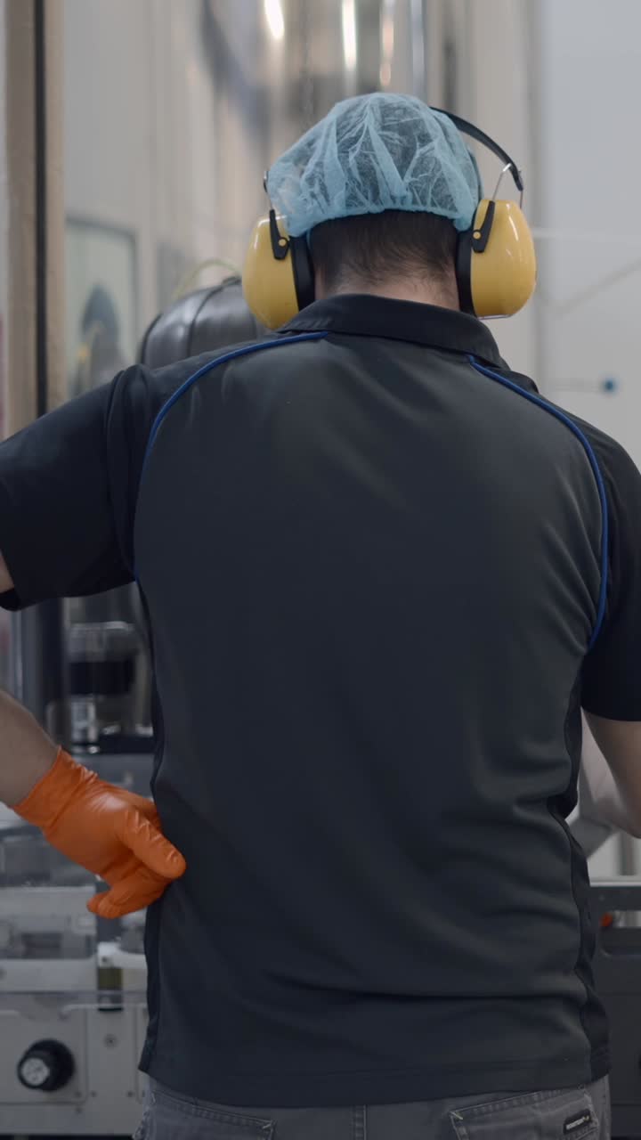 Worker in Protective Gear at a Production Facility