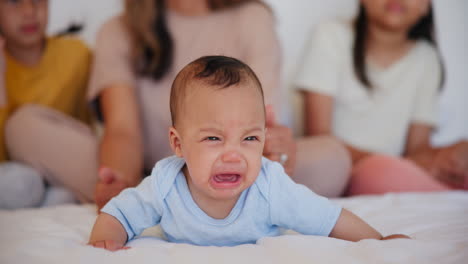 baby, crying and sad newborn on bed