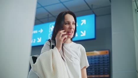 woman talking on phone at the airport