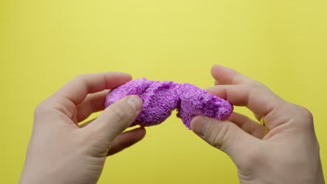 purple floam with glitter in person hands, pov