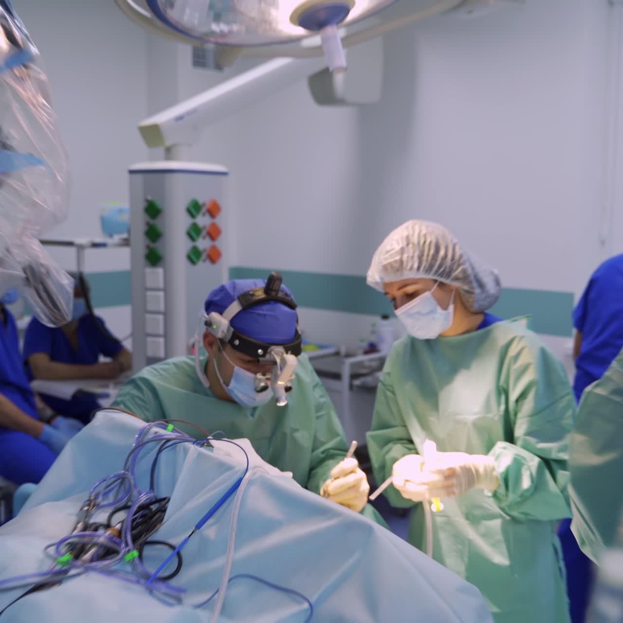 Lots of medics working at operation in surgical room. High angle perspective on medical procedure in modern hospital