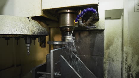 high-speed cnc drilling, coolant spraying, and metal shavings flying