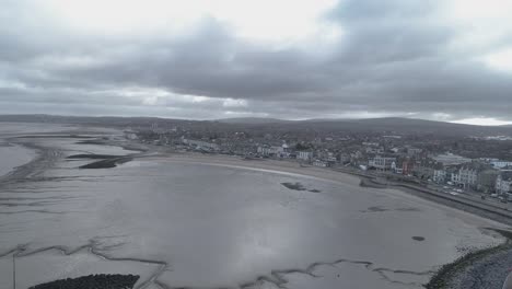 aerial push in over a cloudy morecambe bay, lancashire