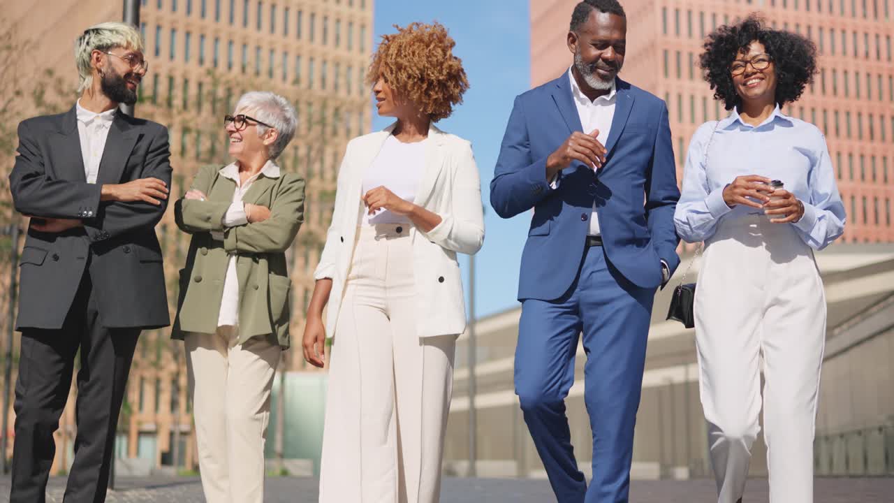 Diverse business people talking relaxed while strolling in the city