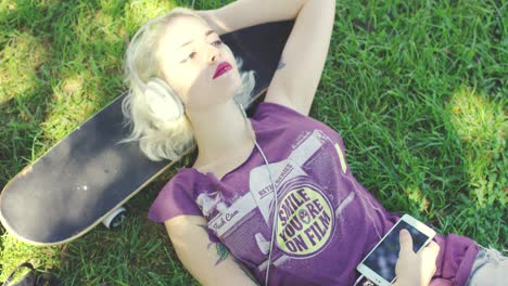 young blond woman relaxing listening to music