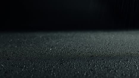 glittering water droplets. black surface in drops of water. abstract wet surface.