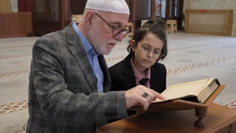 old man teaching quran