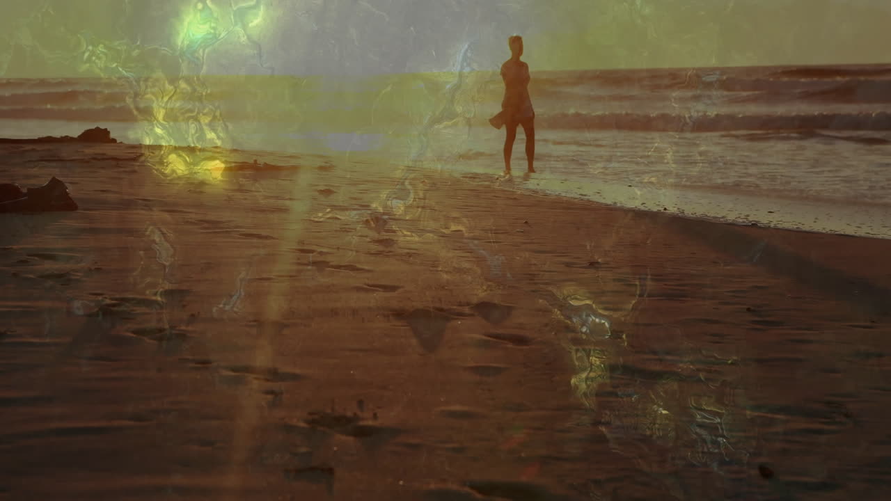 Walking on beach, silhouette of person with animation of abstract light patterns