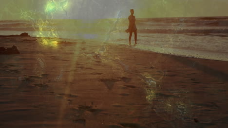 walking on beach, silhouette of person with animation of abstract light patterns
