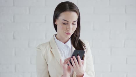 Beautiful-elegant-business-woman-browsing-her-smartphone