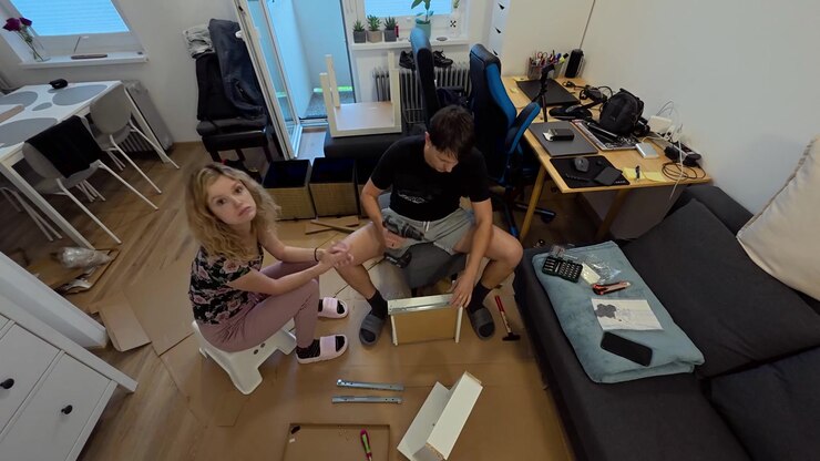 Couple assembling furniture on living room floor with tools and parts in home interior, timelapse