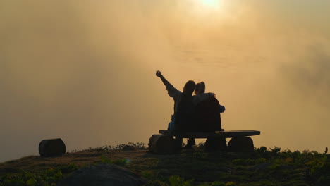 friends enjoying sunset view from mountaintop