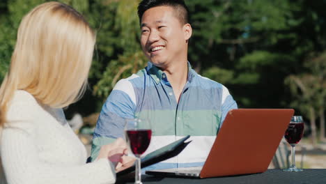 happy couple drinking and smoking using technology