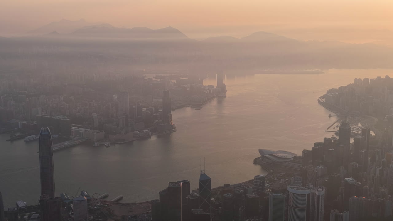 Aerial view of Hong Kong skyline at golden hour featuring IFC and ICC towers, symbolizing global finance, modern architecture, and a vibrant hub for travel and business
