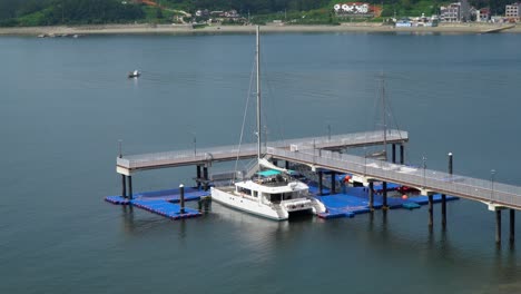 catamaran boat for tourists docked at terminal by the calm sea in summer