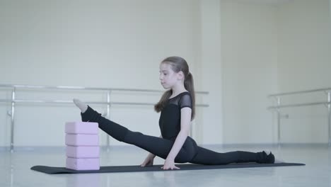 young ballerina practicing dance moves in studio