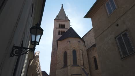 st. george's basilica in prague under a bright blue sky with surrounding historical buildings
