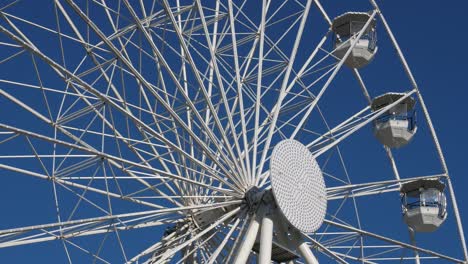 ferris wheel in action againts a blue sly.