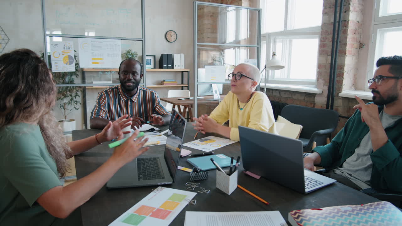 Diverse Colleagues and Man in Wheelchair Having Business Meeting