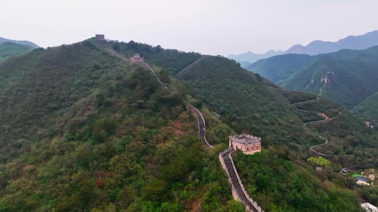 Aerial view rising over watchtowers, along the Great Wall, cloudy day in China