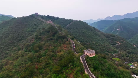 aerial view rising over watchtowers, along the great wall, cloudy day in china