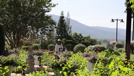 a family explores a lush garden with sculptures