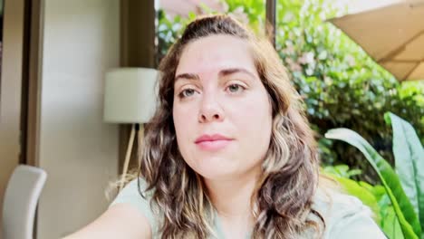 pensive woman with green eyes in a calm natural setting, in cafe shop