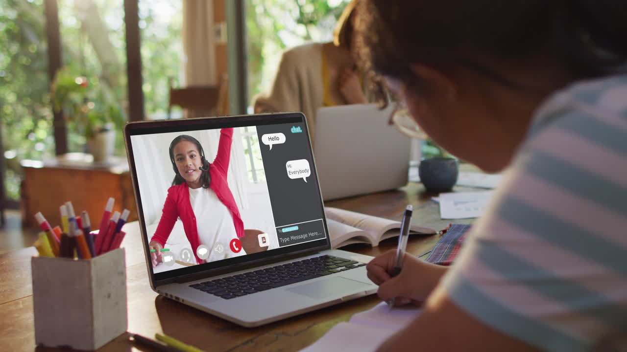 Composite video of girl using laptop for online lesson at home, with girl raising hand on screen