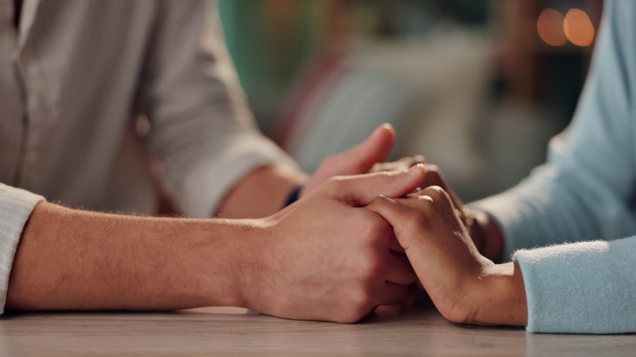 Interracial couple holding hands in a tender moment