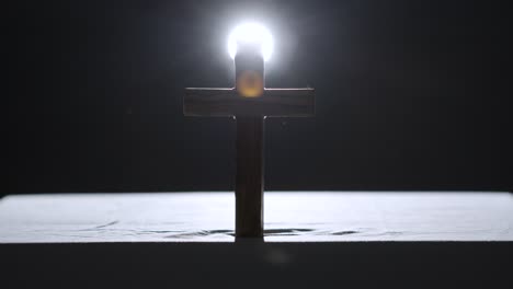 Religious-Concept-Shot-With-Wooden-Cross-On-Altar-With-Spotlight-Behind