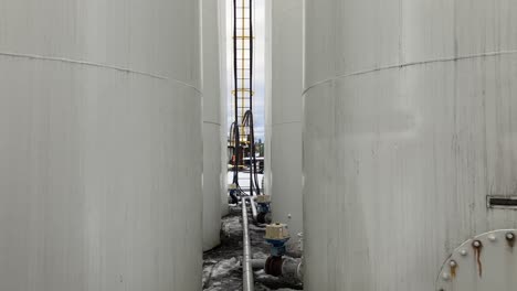 medium shot of large bulk fuel plant with pipes and valves in motion